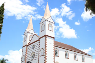 white and brown concrete church under blue sky during daytime