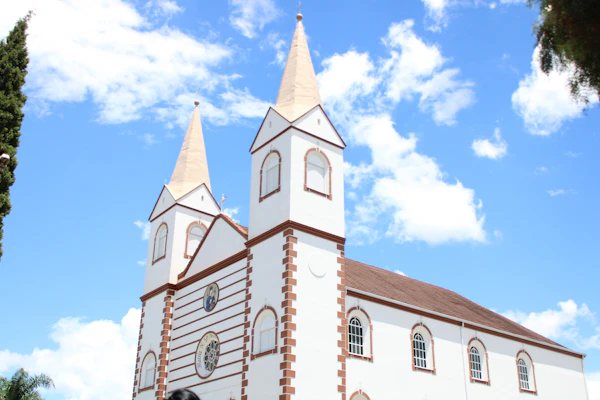 white and brown concrete church under blue sky during daytime