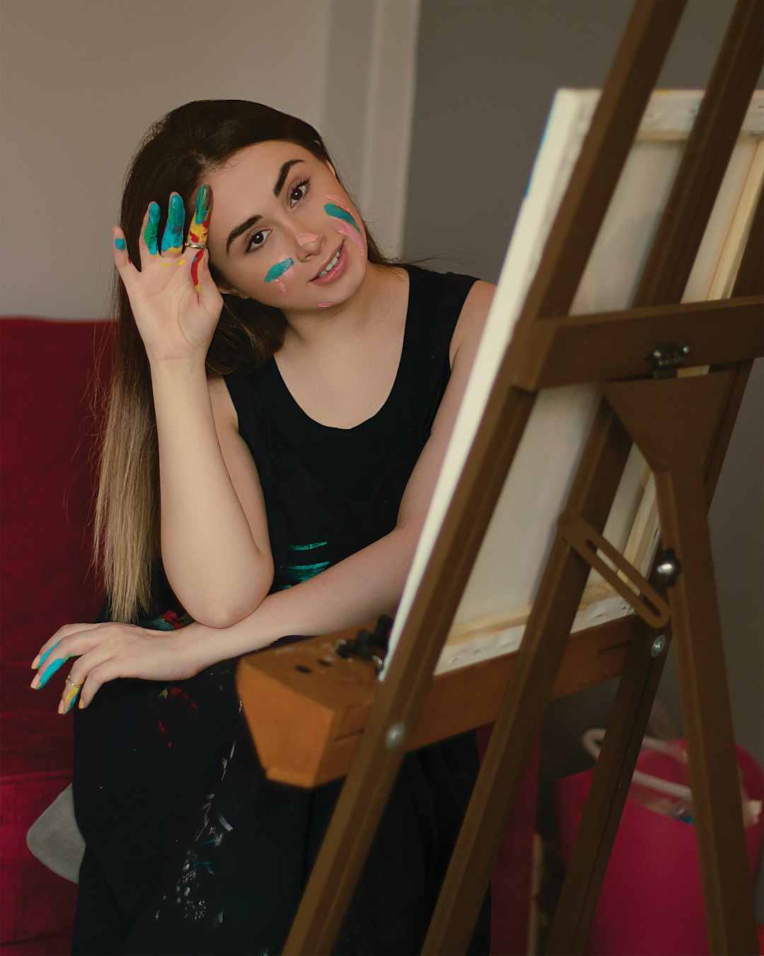 woman in black tank top sitting on brown wooden chair