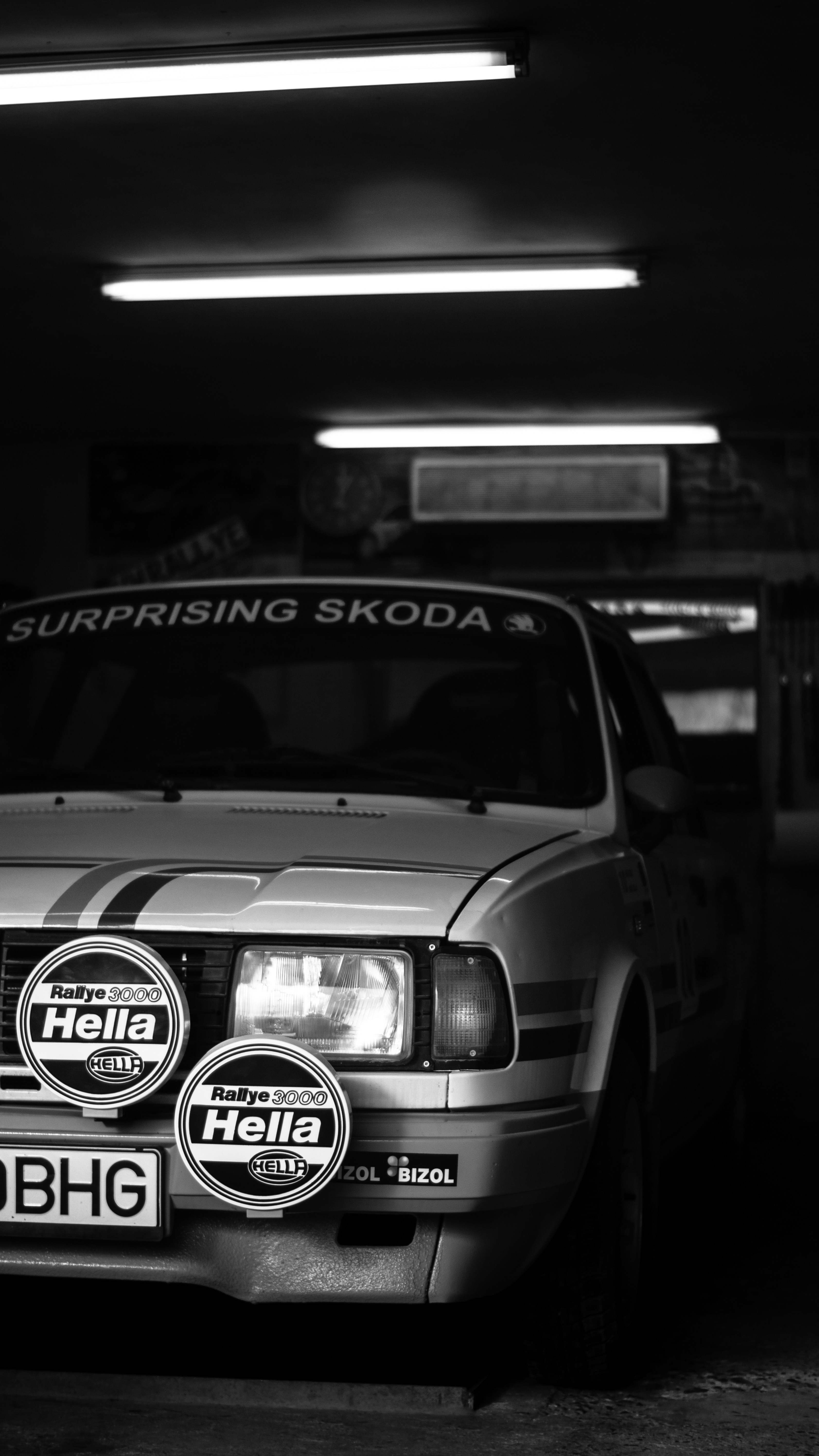 grayscale photo of car in a parking lot