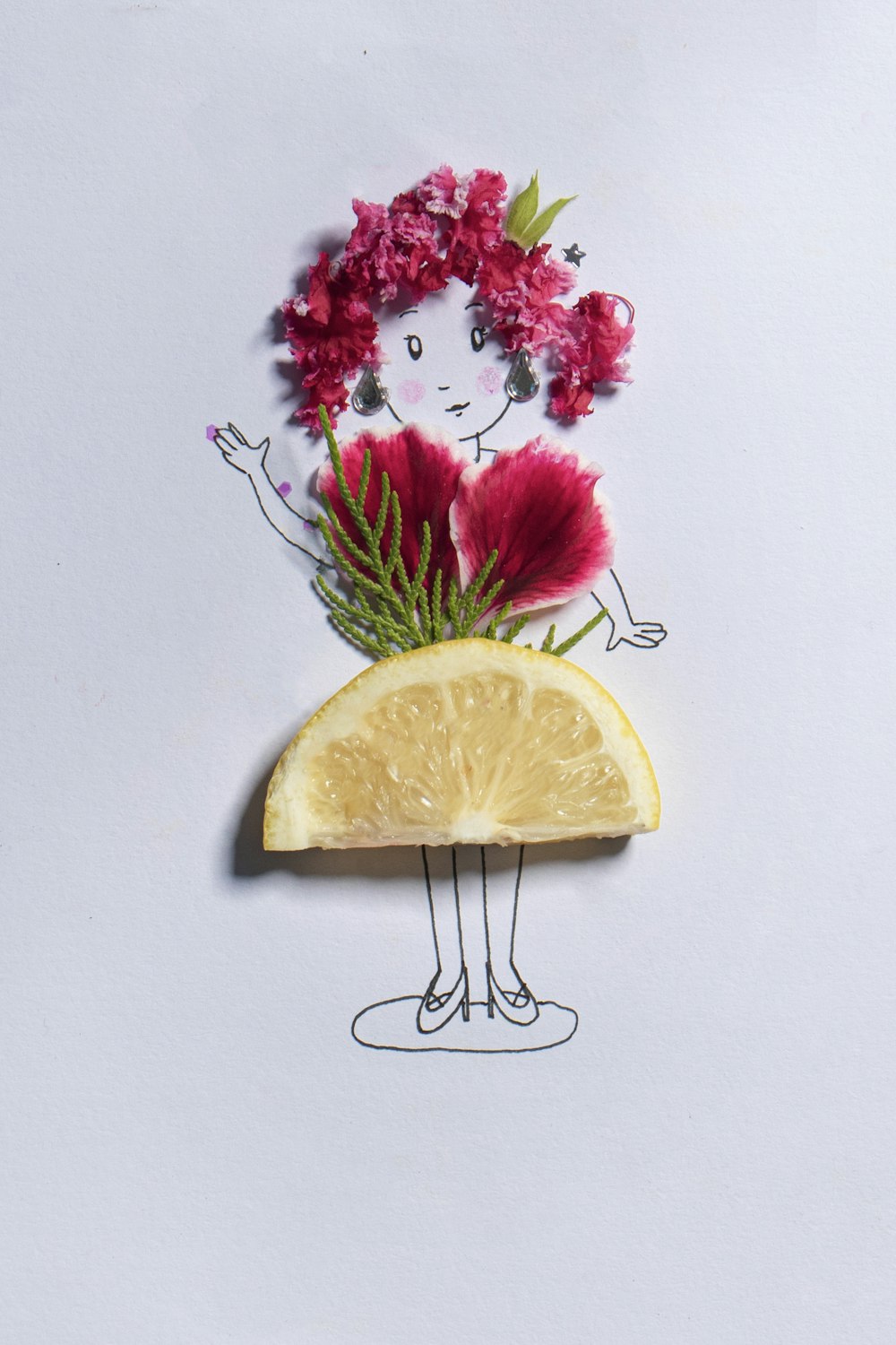 sliced lemon beside pink flowers