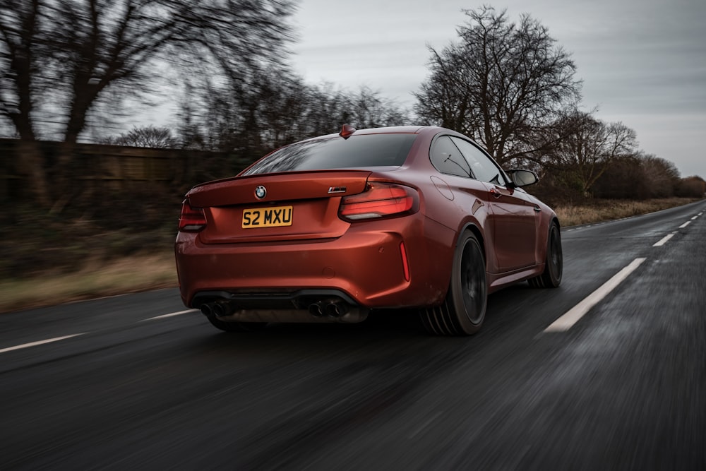 red bmw m 3 on road during daytime