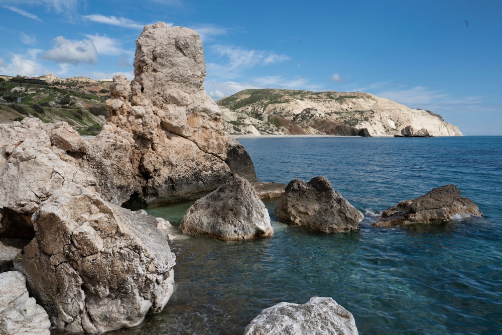 brown rock formation on sea during daytime