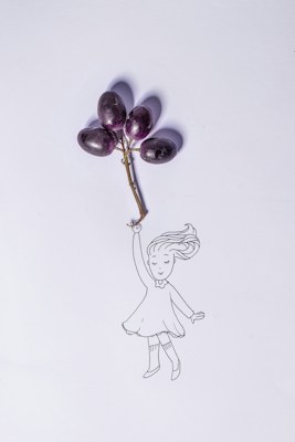A whimsical illustration of a girl holding a bunch of grapes as if they are balloons, with the grapes attached by a small vine. The girl's hair flows as if she is being lifted gently by the grapes.