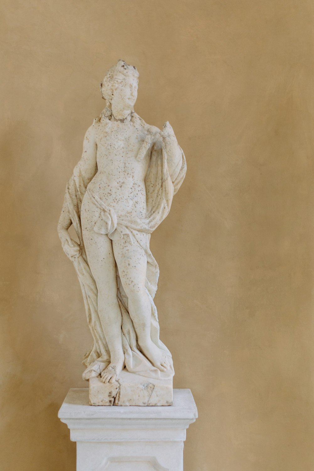 white concrete statue of woman