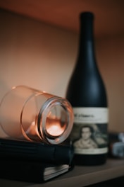 A cozy tasting setup with a glass of red wine, WSET textbooks, and warm natural light.