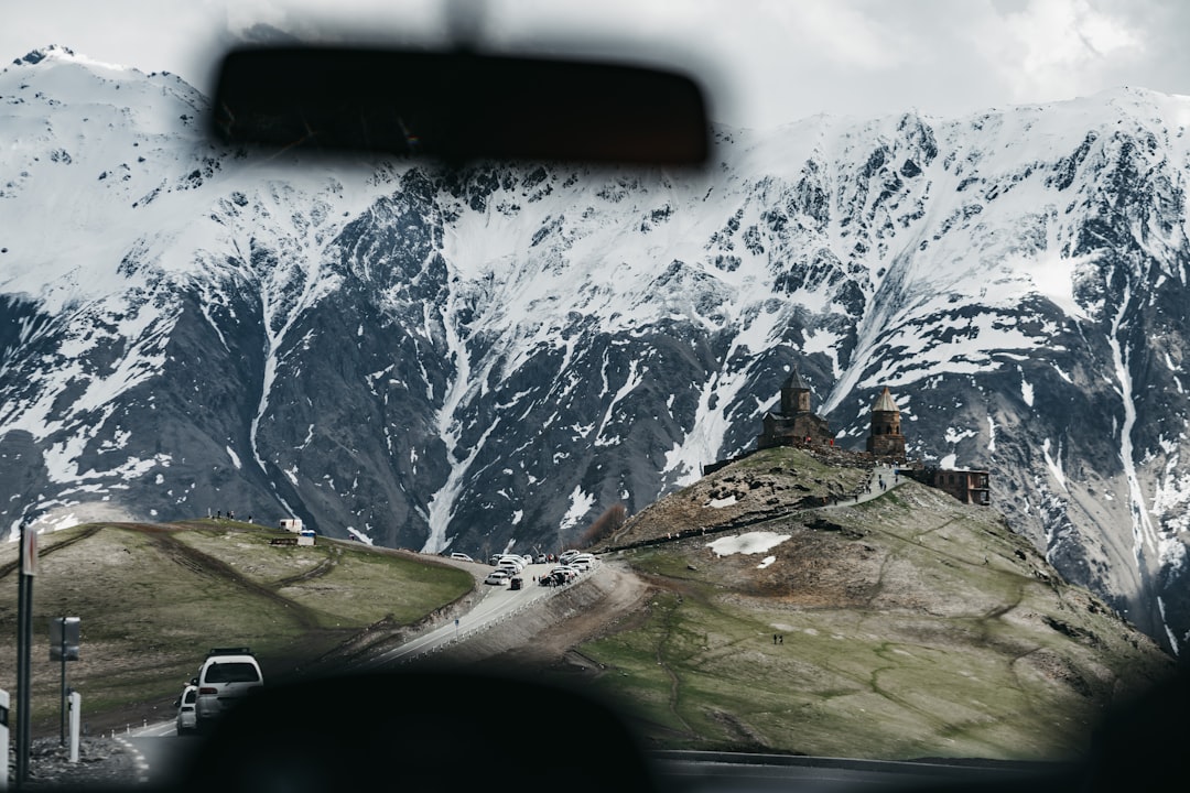 white car on road near mountain during daytime