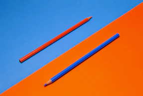 blue pencil on orange surface