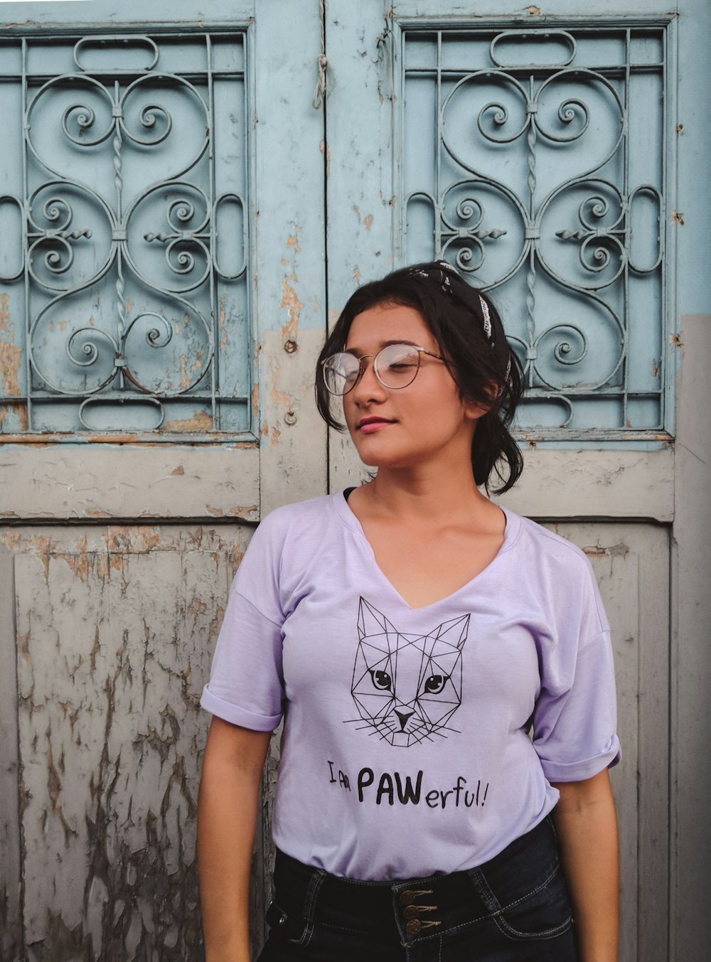 woman in white crew neck t-shirt standing beside white wooden door