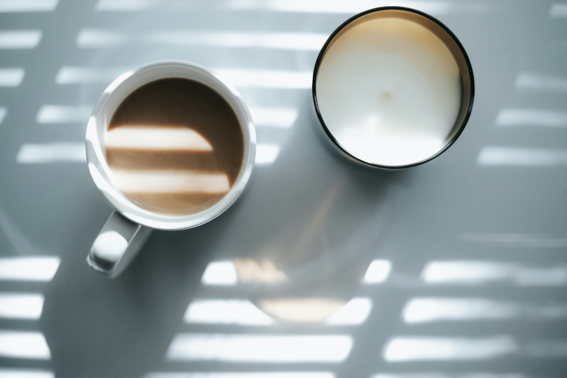 2 white ceramic mugs on white table