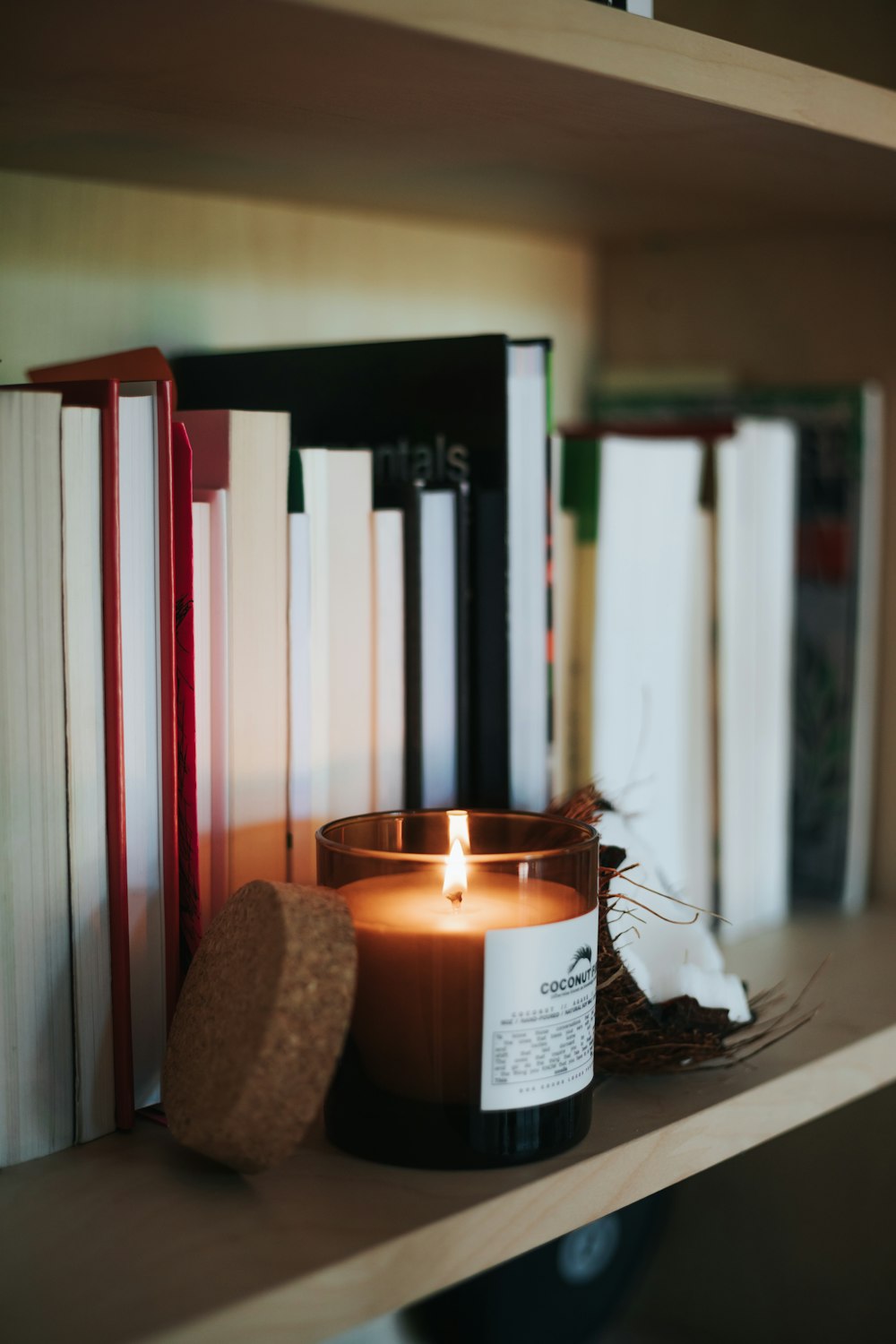 lighted candle on brown wooden holder