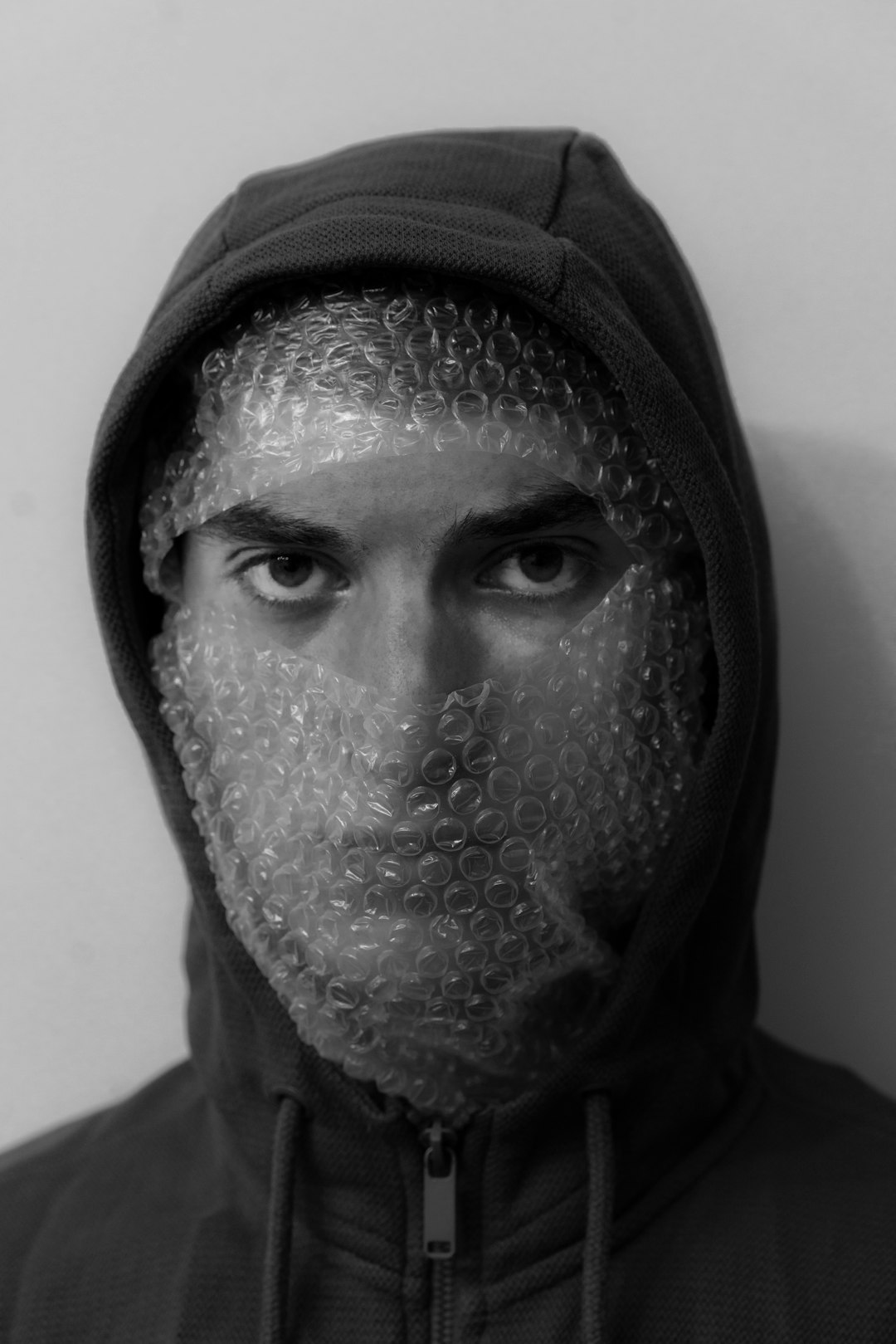 grayscale photo of man wearing black and white hijab