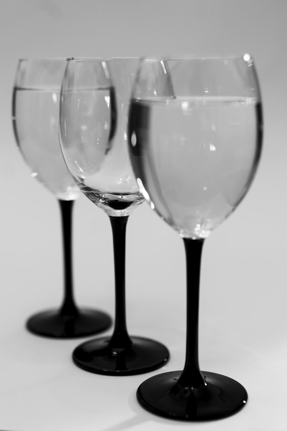 2 clear wine glasses on white table