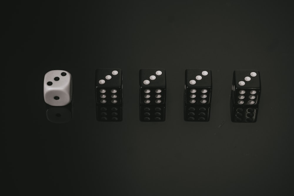 white and black dices on black surface