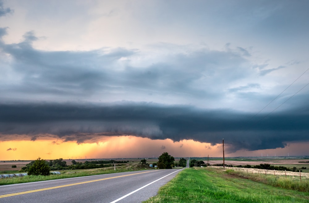 gray asphalt road under gray clouds