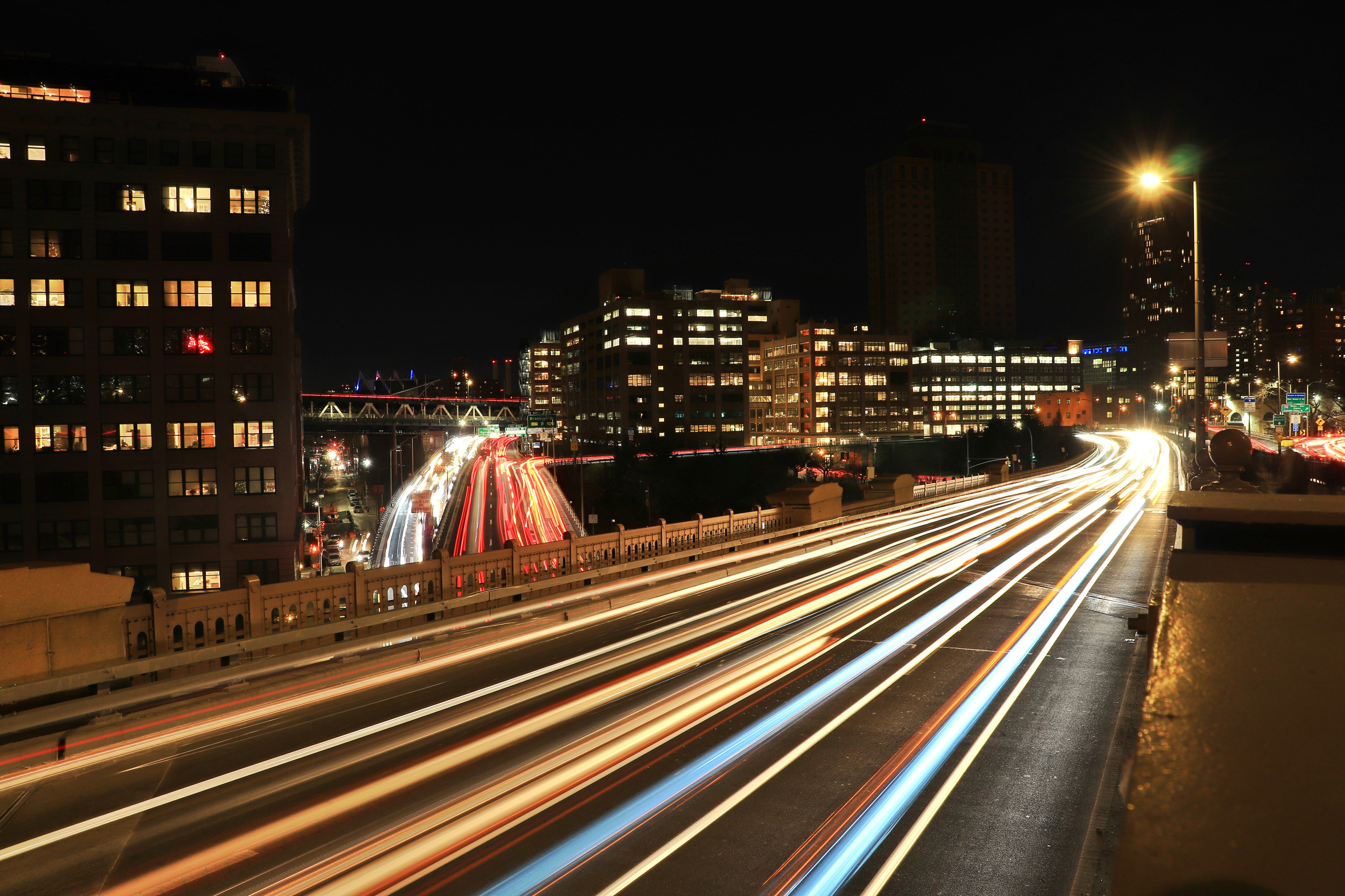 Highway traffic at night with light trails from vehicles, symbolising global fuel consumption and CO2 emissions from road transport