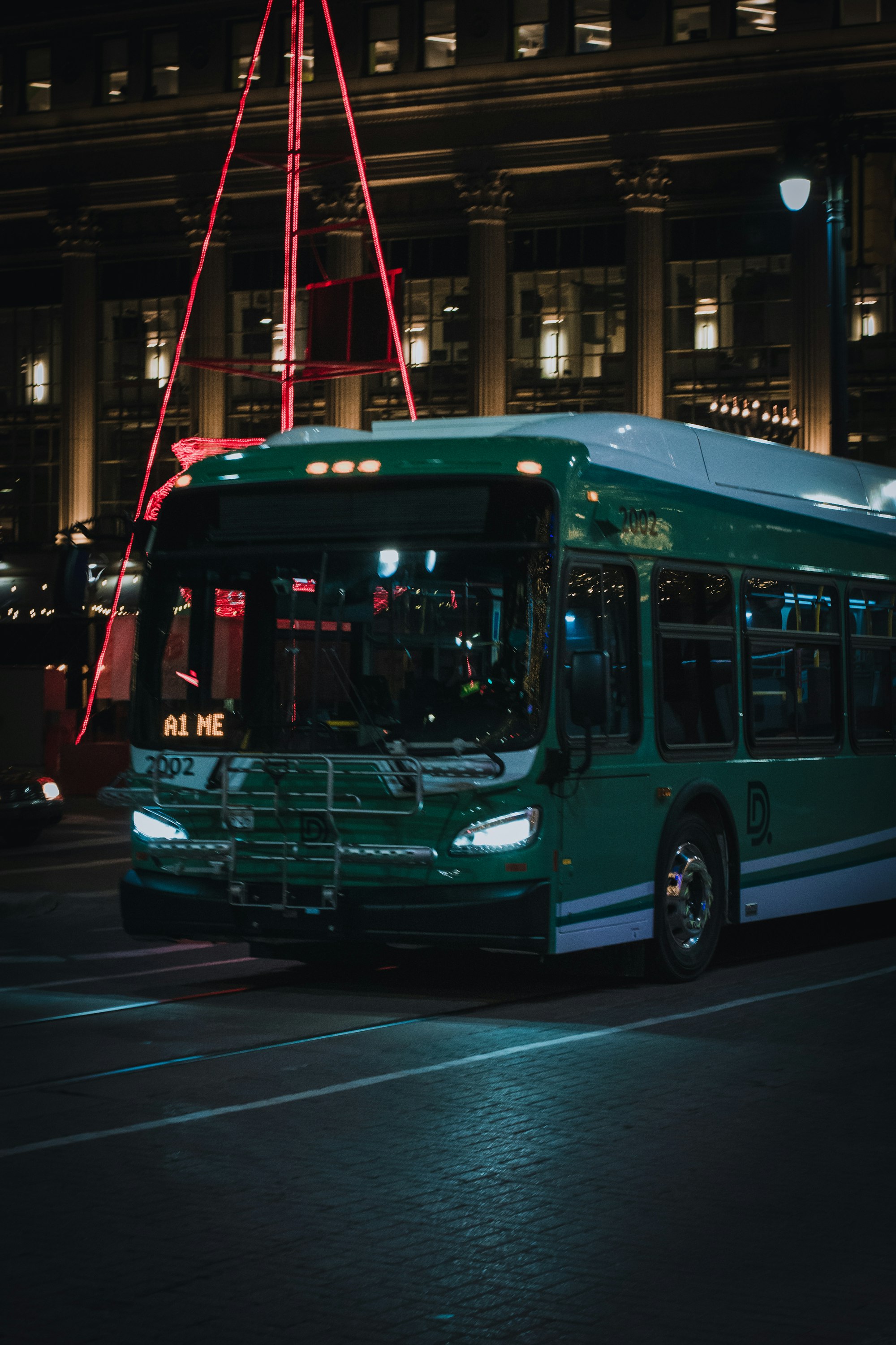 red and white bus on road during night time