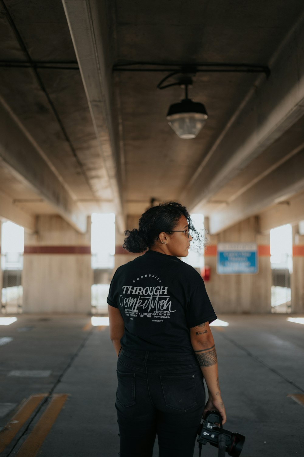 woman in black crew neck t-shirt standing on hallway
