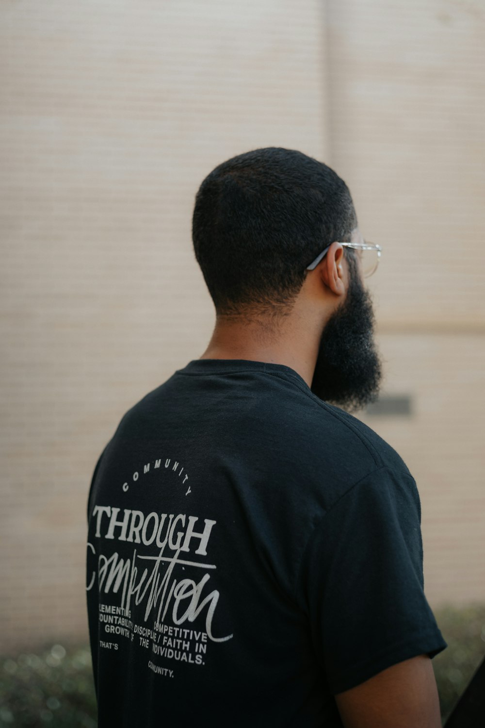 man in black crew neck shirt wearing black sunglasses