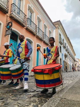 people playing musical instruments on street during daytime