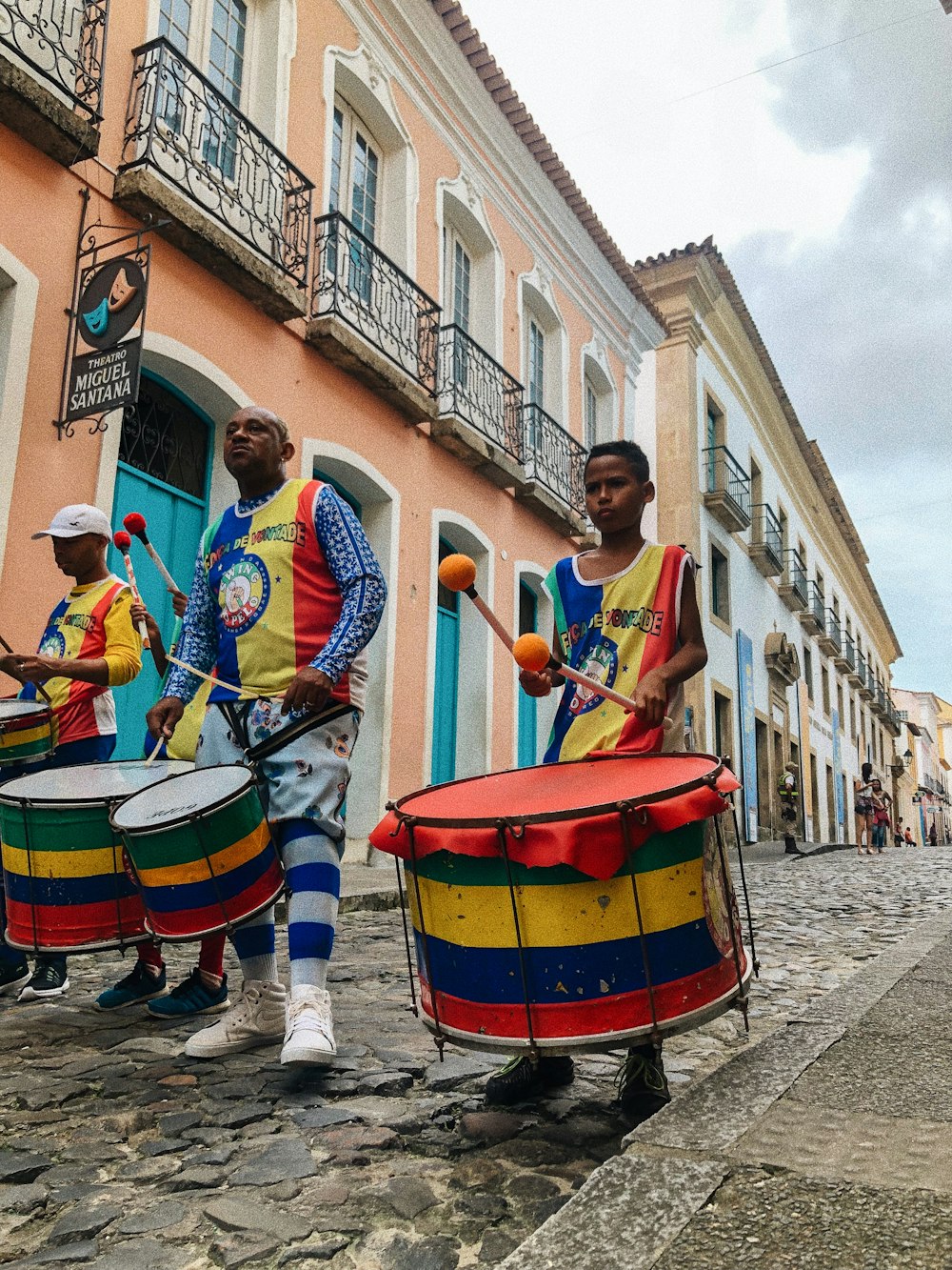 people playing musical instruments on street during daytime