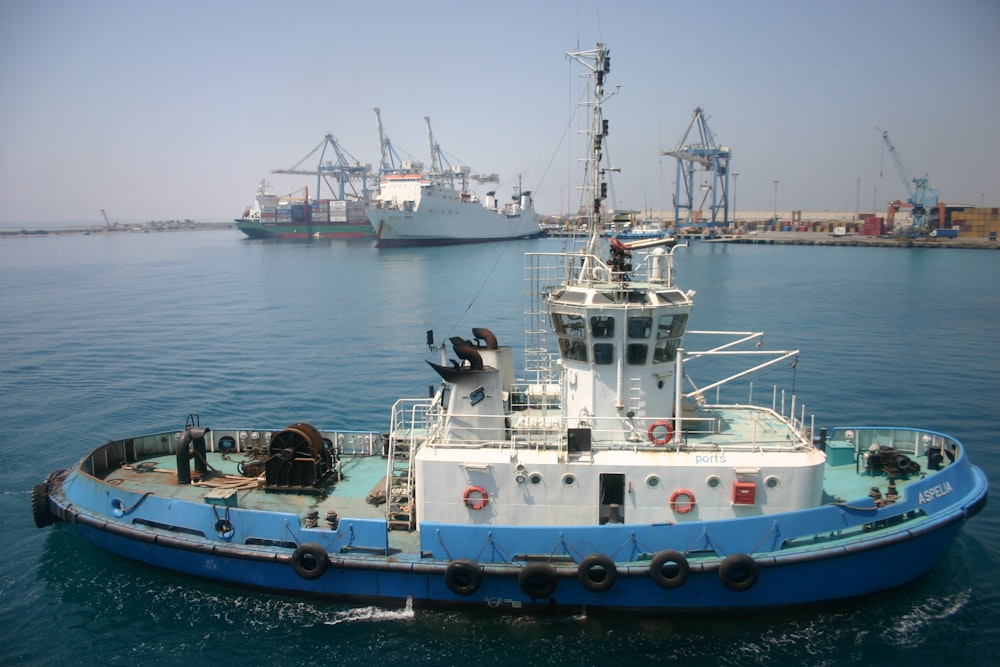 white and blue ship on sea during daytime