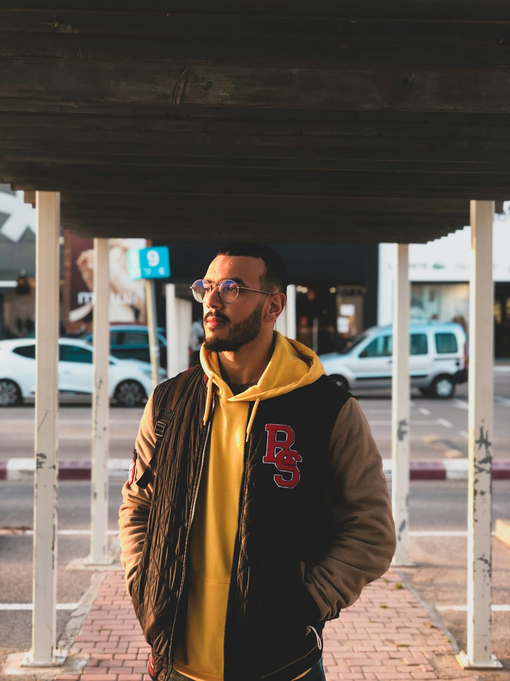 man in brown zip up jacket wearing black sunglasses