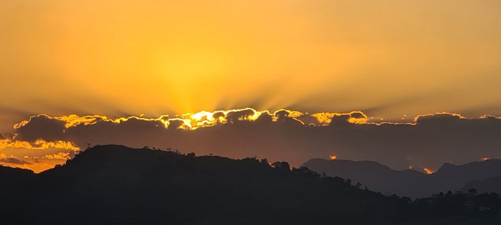 silhouette of mountains during sunset