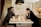 A friendly agent discussing terms with a homeowner at a kitchen table.