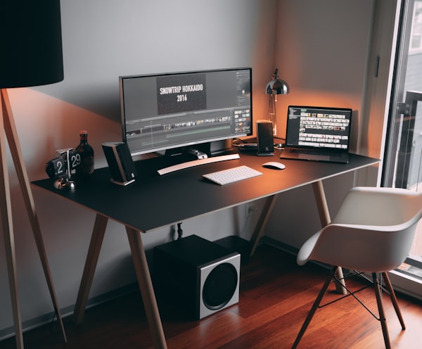 black flat screen computer monitor on black wooden table