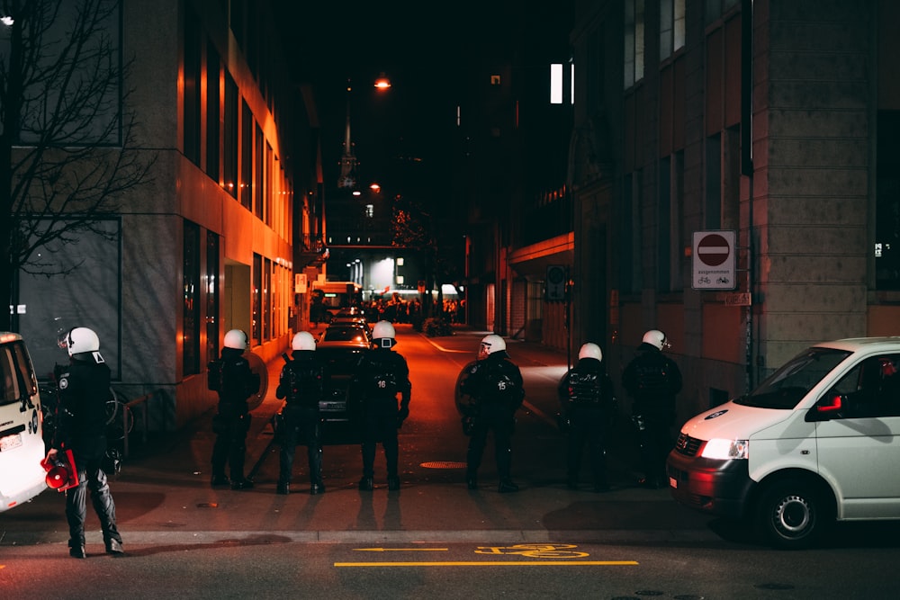 people walking on sidewalk during night time