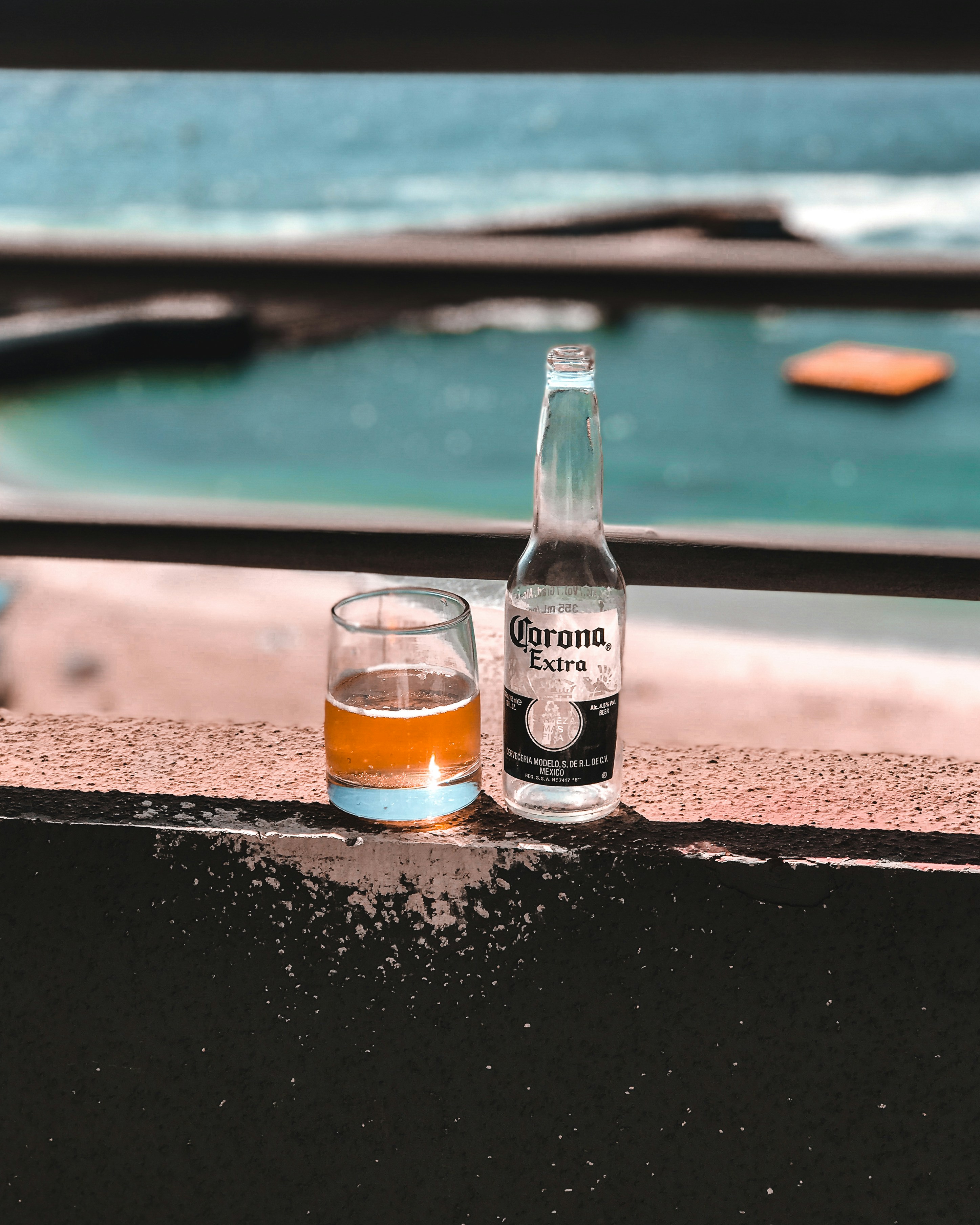 clear glass bottle on brown concrete floor