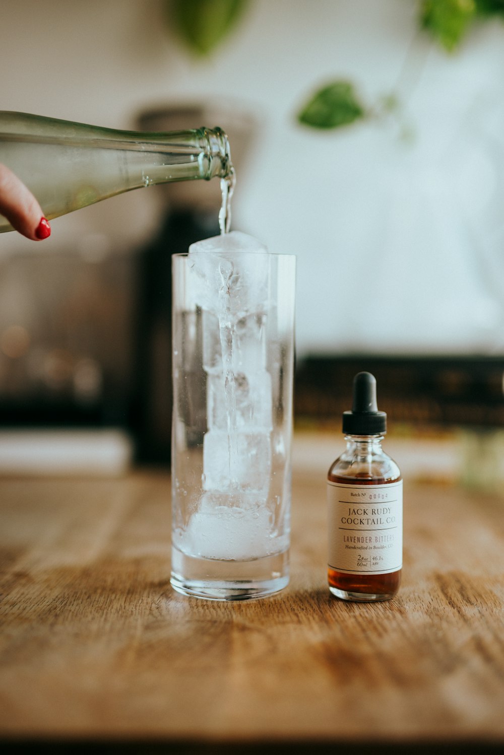 clear glass bottle on brown wooden table