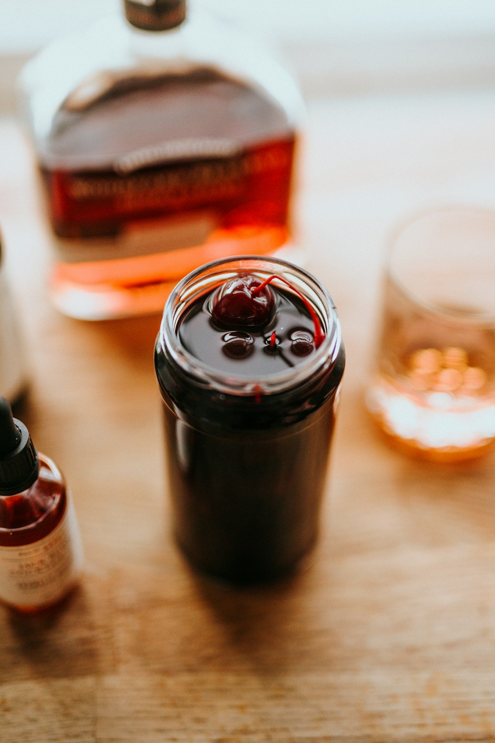 clear drinking glass beside black bottle