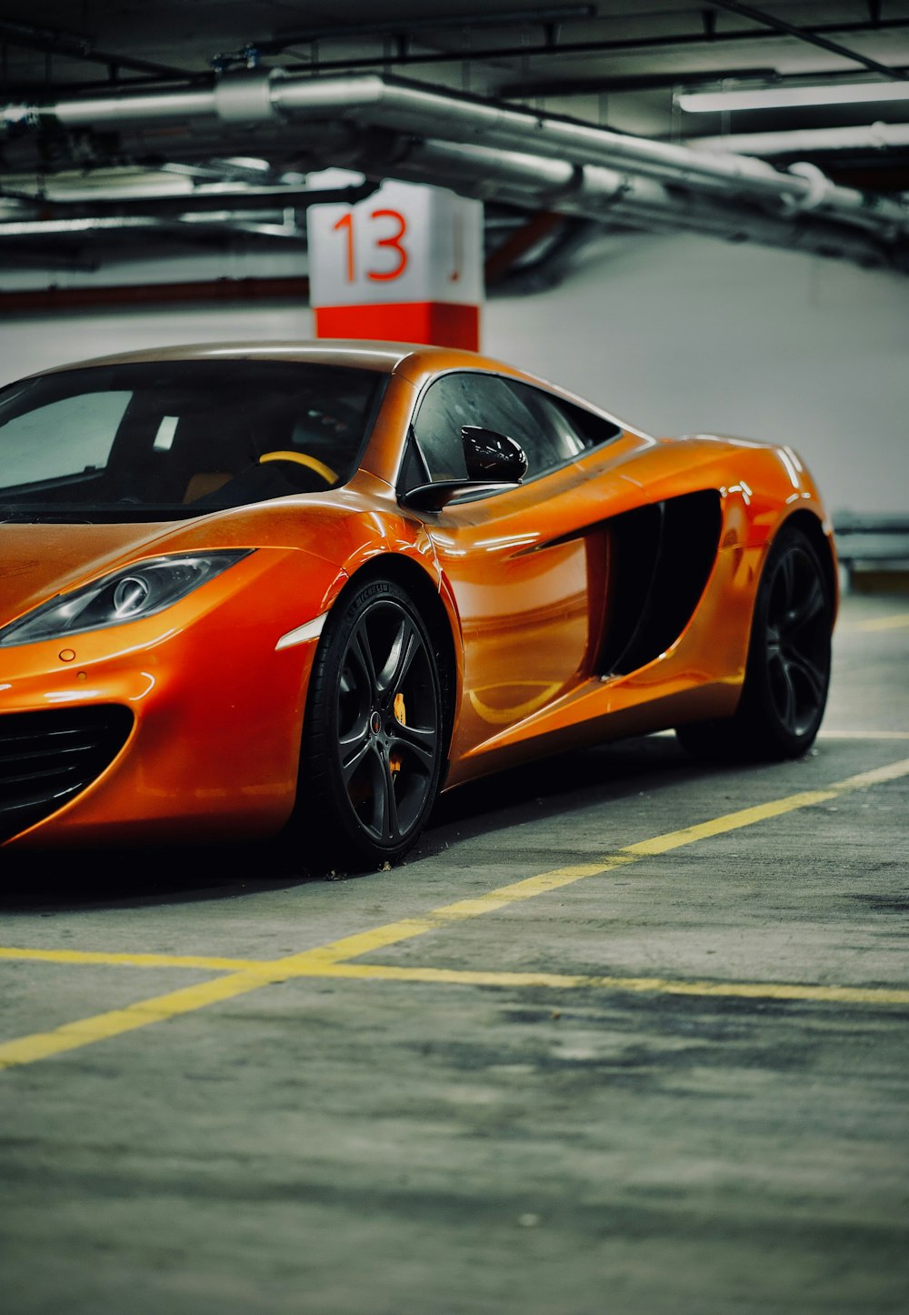 orange lamborghini aventador on gray asphalt road