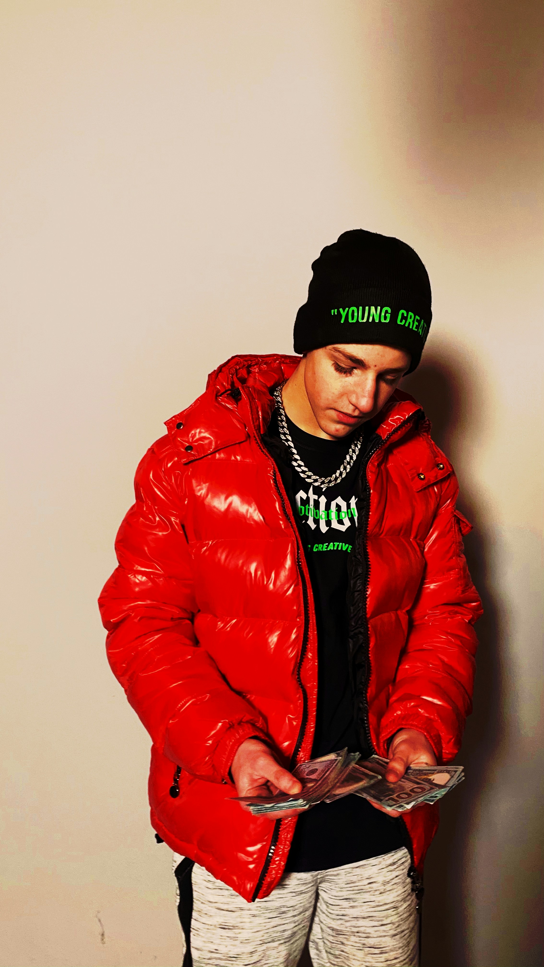 man in red leather jacket wearing black knit cap