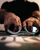 person wearing silver ring on macbook pro