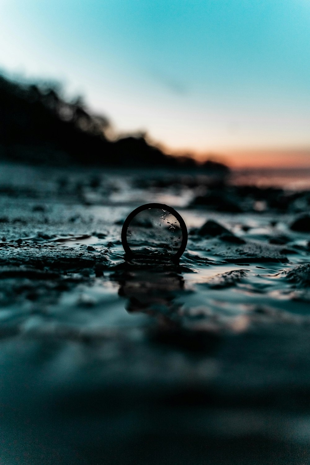 water drop on body of water during sunset