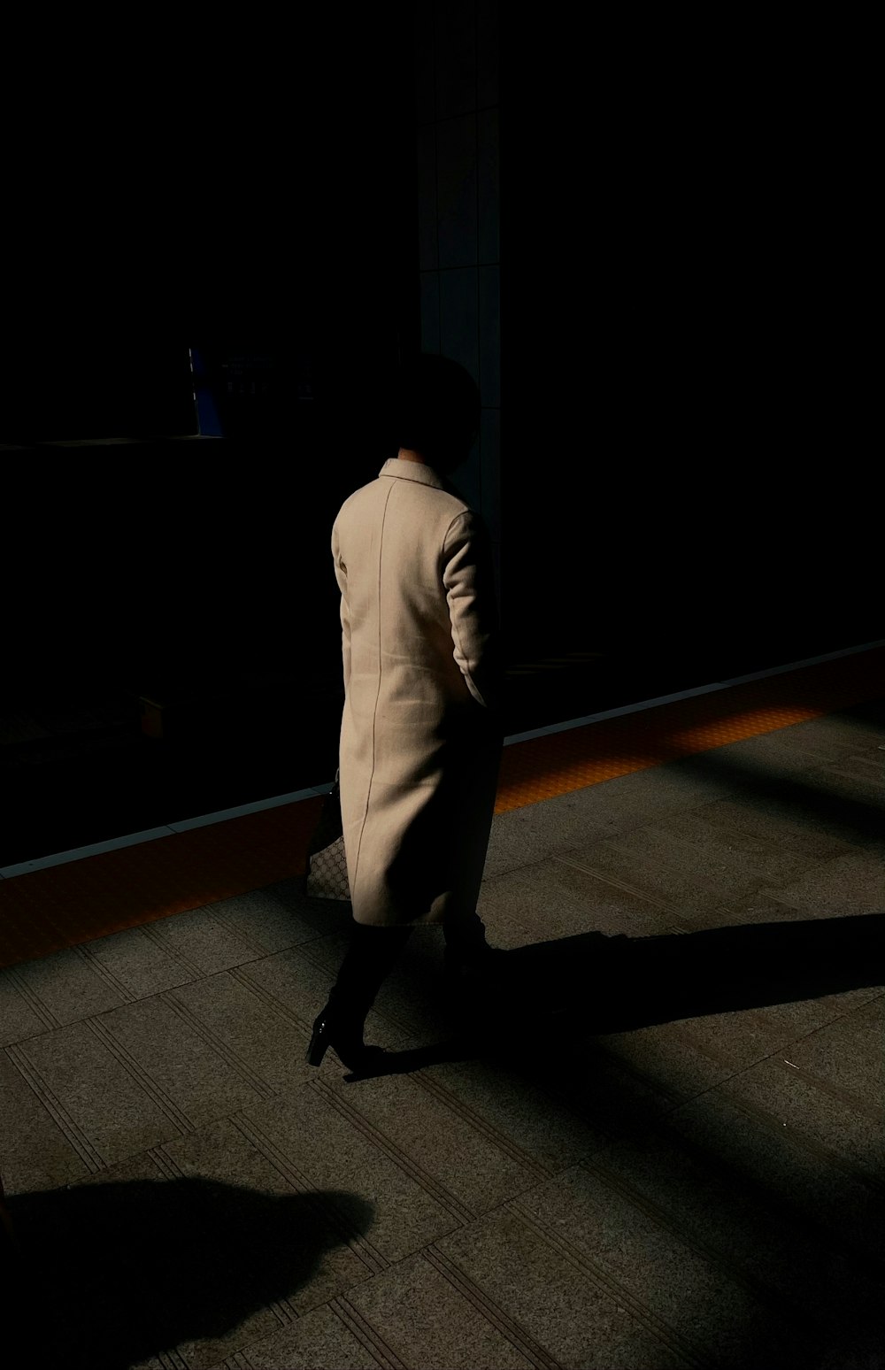 man in white suit walking on brown wooden floor
