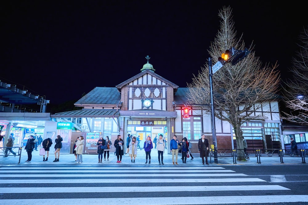 people walking on street during night time