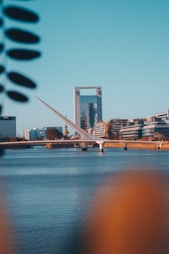 bridge over water near city buildings during daytime