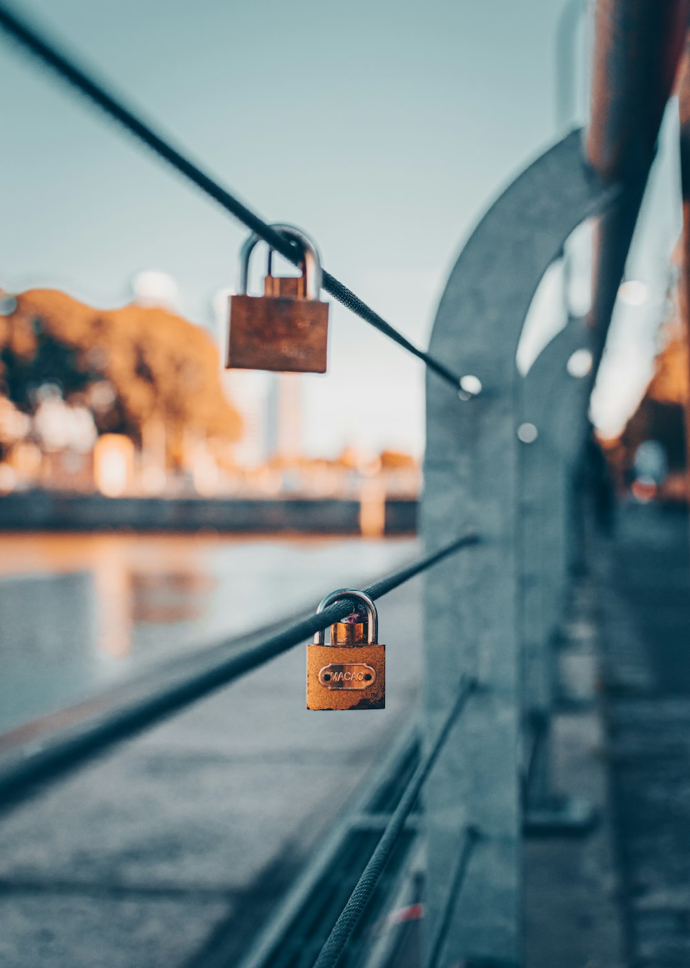 brown padlock on black metal fence