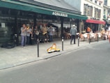 A group of young musicians jamming together on a sidewalk corner.