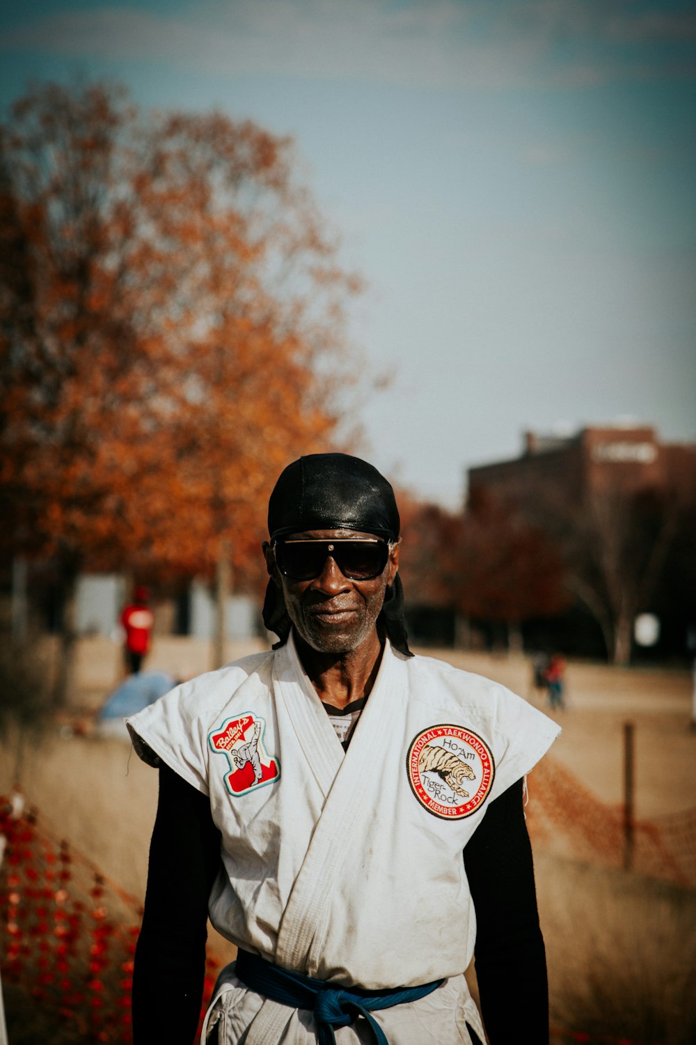 man in white and black polo shirt wearing black sunglasses