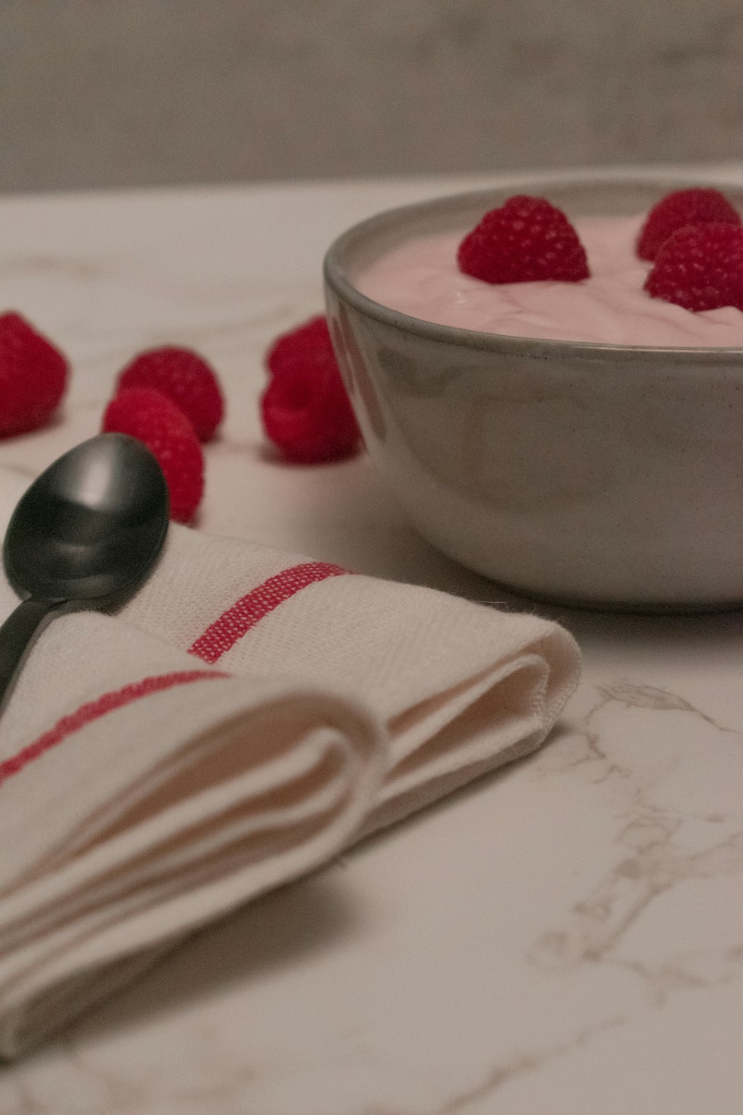 red strawberries in white ceramic bowl