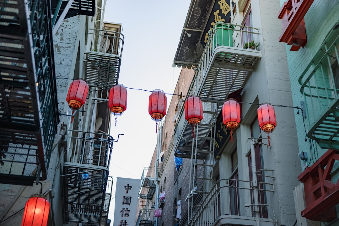 red paper lanterns on gray concrete building during daytime