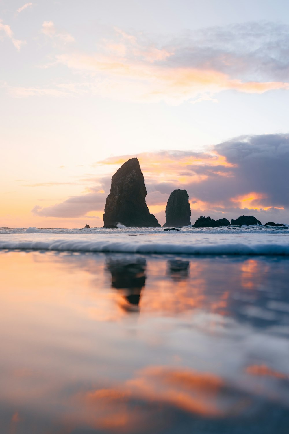 rock formation on sea during sunset