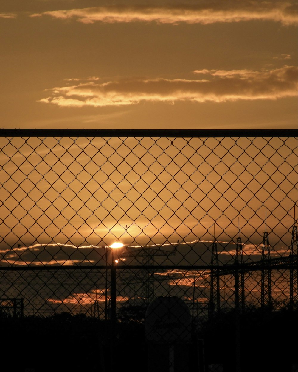 black metal fence during sunset