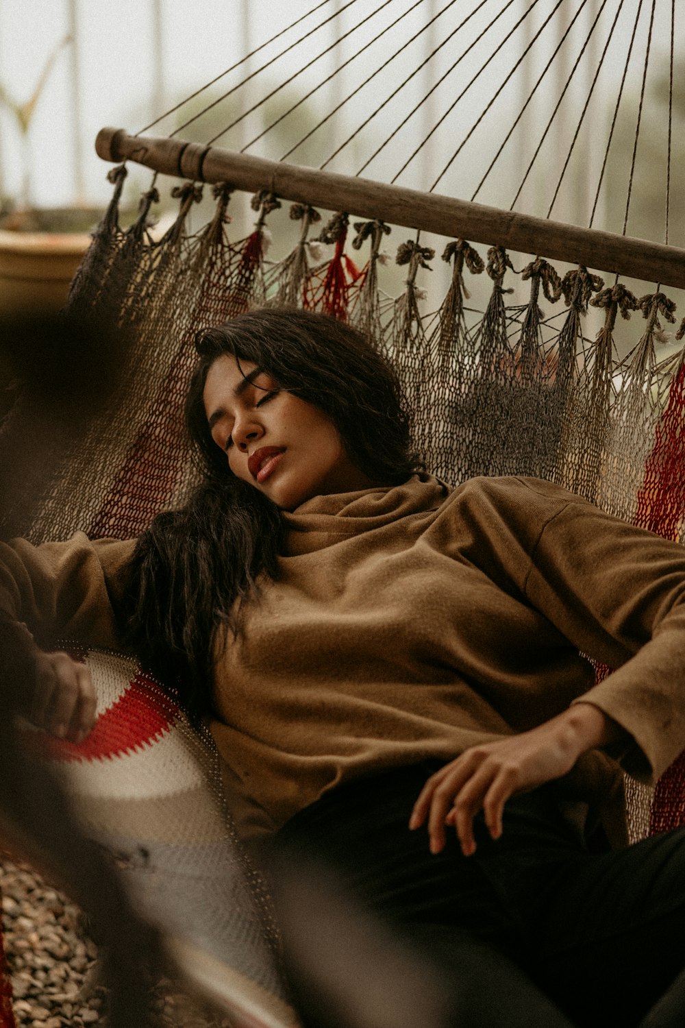 woman in brown sweater lying on floor