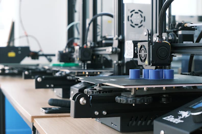 Precision 3D printed mechanical parts arranged neatly on a white industrial table.